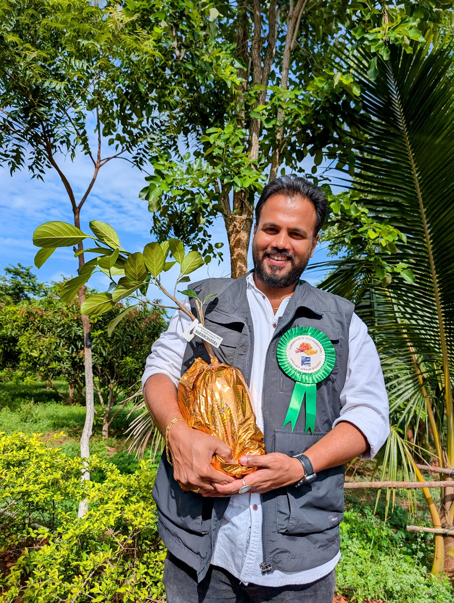 Mithilesh Desai holding jackfruits in his farm